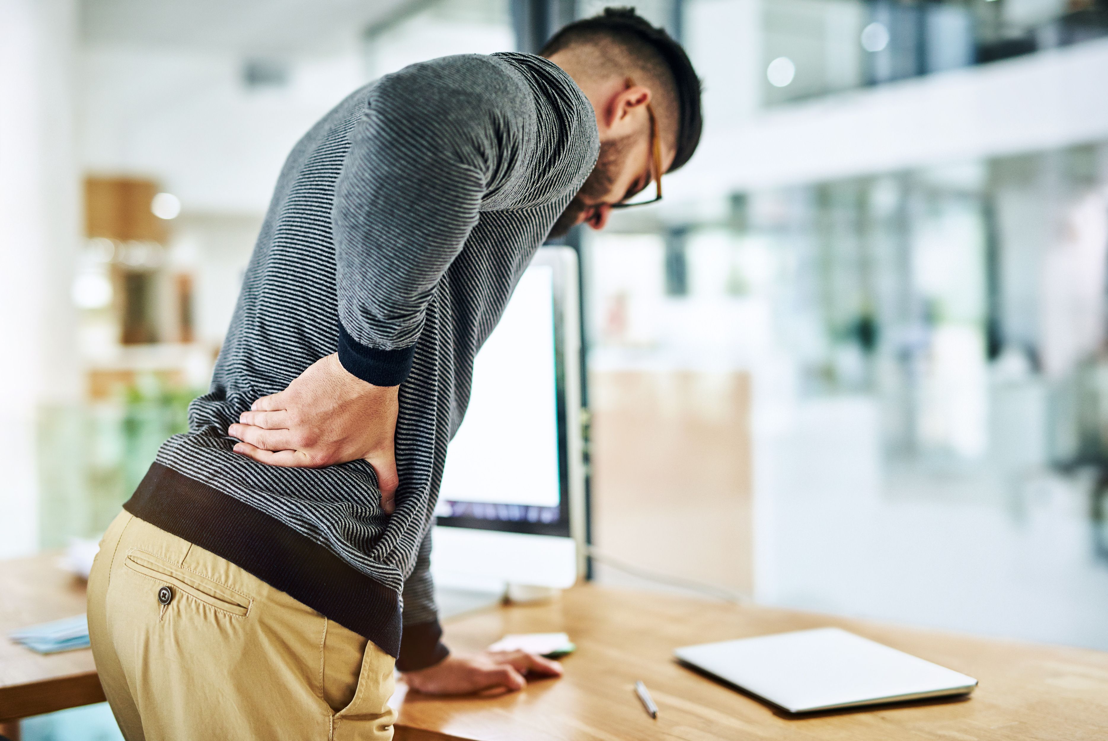 back pain business man social media worker with strain stress anxiety by computer office tech web working with online digital internet project with work problem company