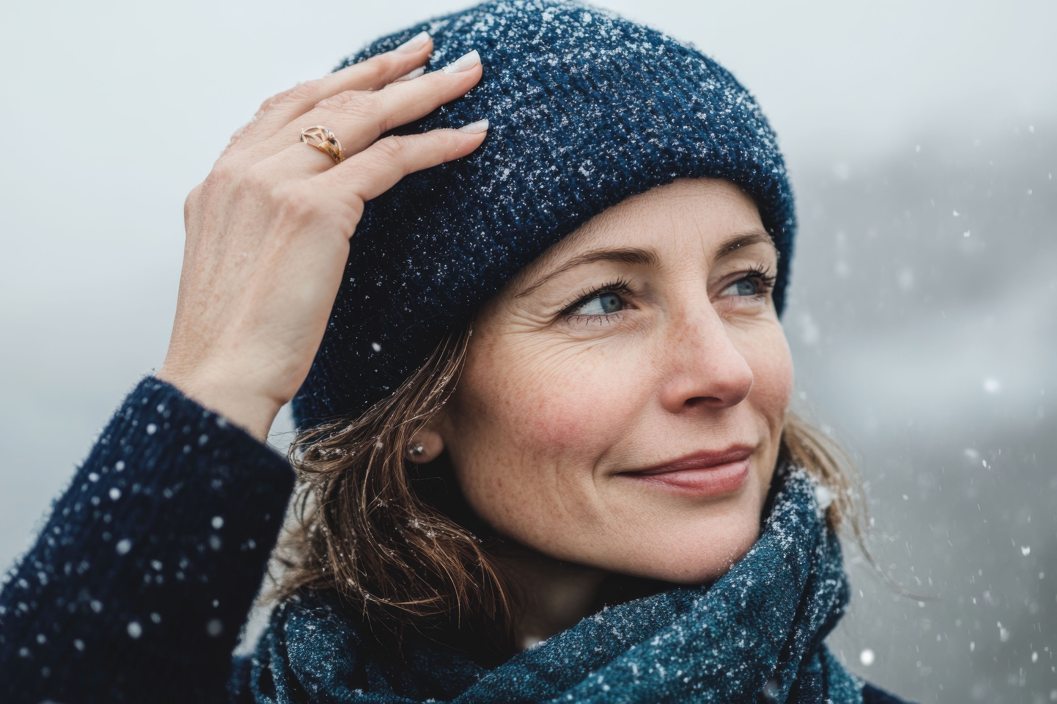 beauty woman model snowy background walking frozen river beautiful young woman wearing blue knitting hat with warm hands smiling looking camera walk frozen river