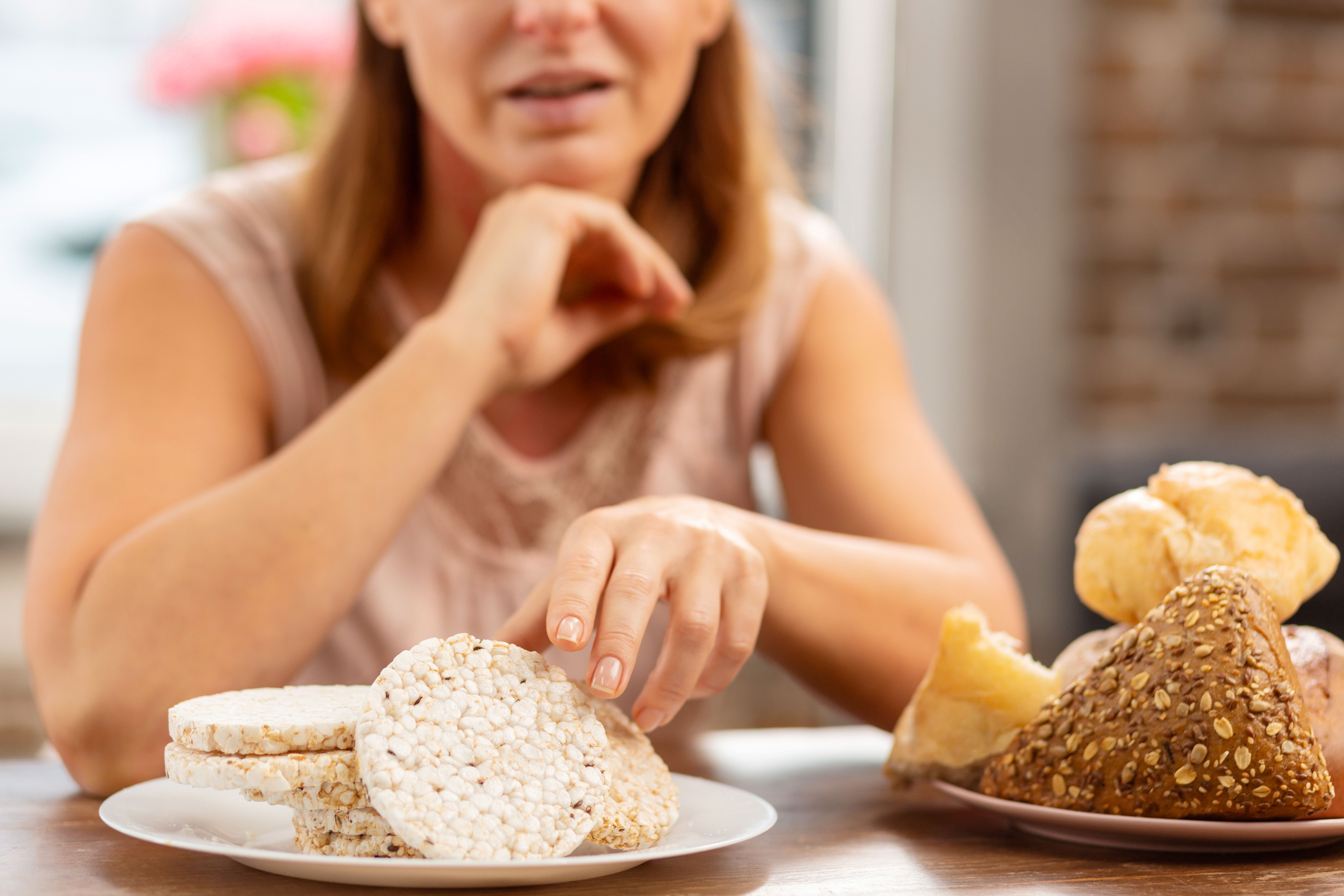 blond haired wife with strong allergy eating gluten free crisps instead bread
