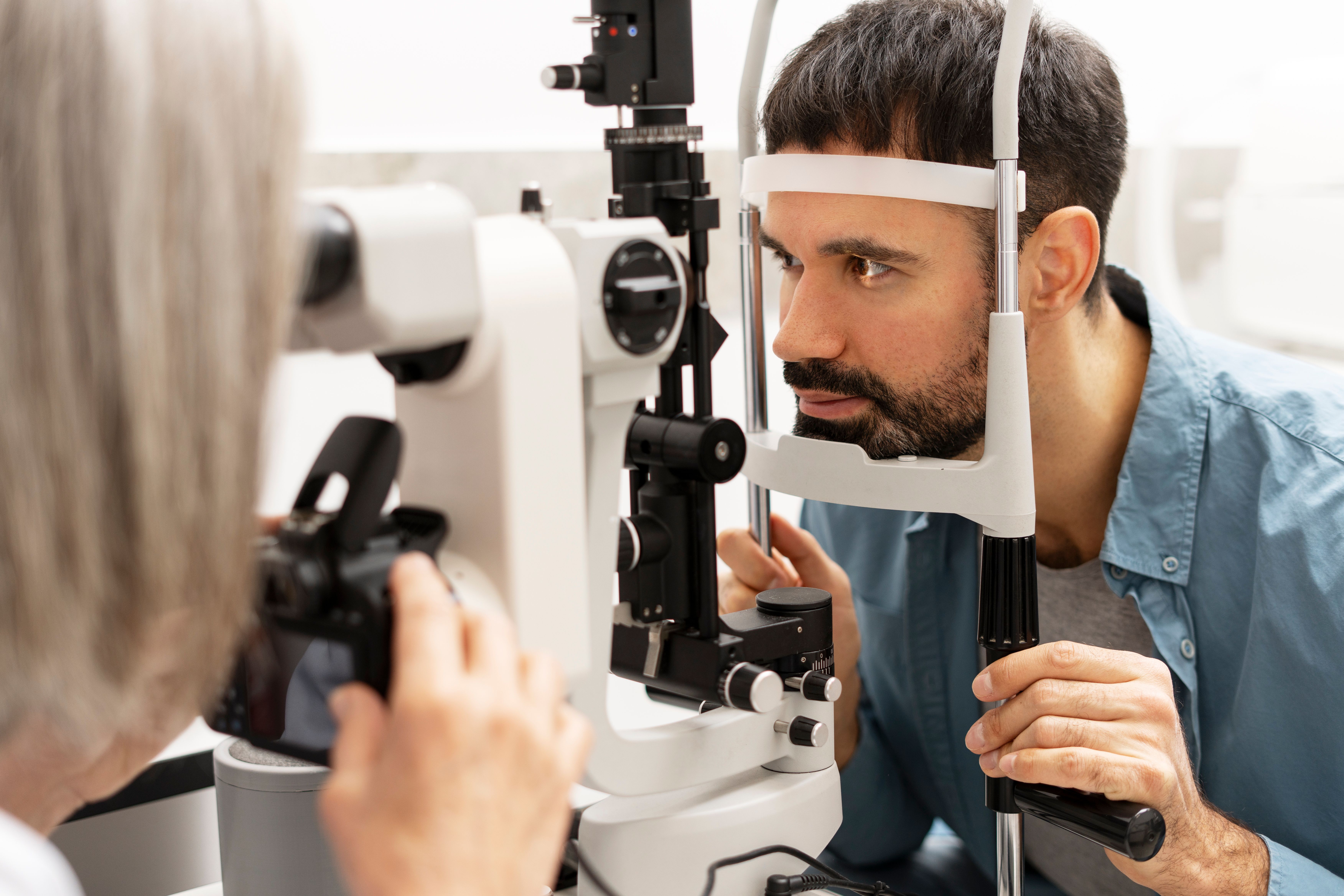 ophthalmologist taking photos patients eye with slit lamp