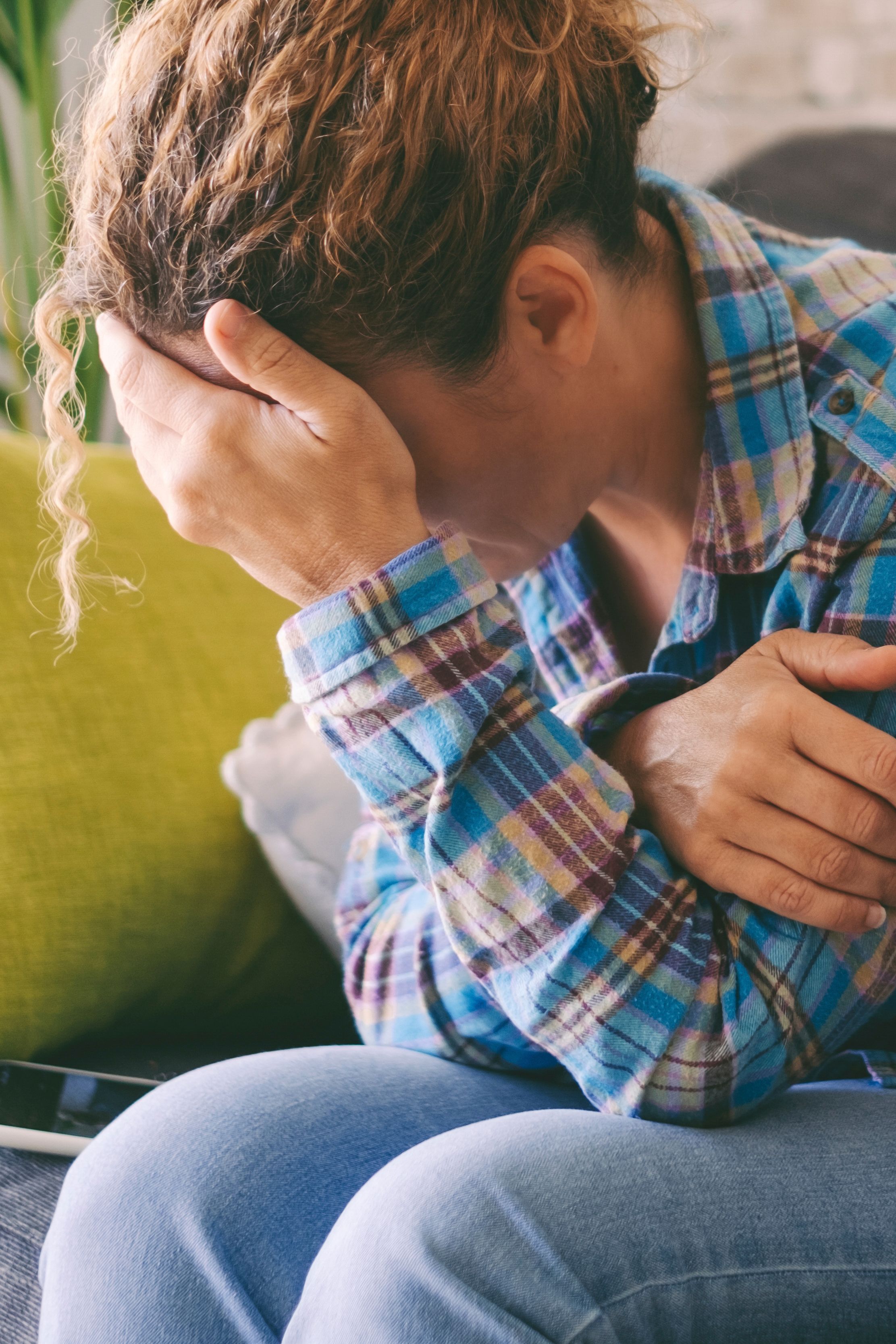 sad tired young woman touching forehead having headache migraine depression upset frustrated girl troubled with problem feel stressed cover crying face with hand suffer from grief sorrow concept