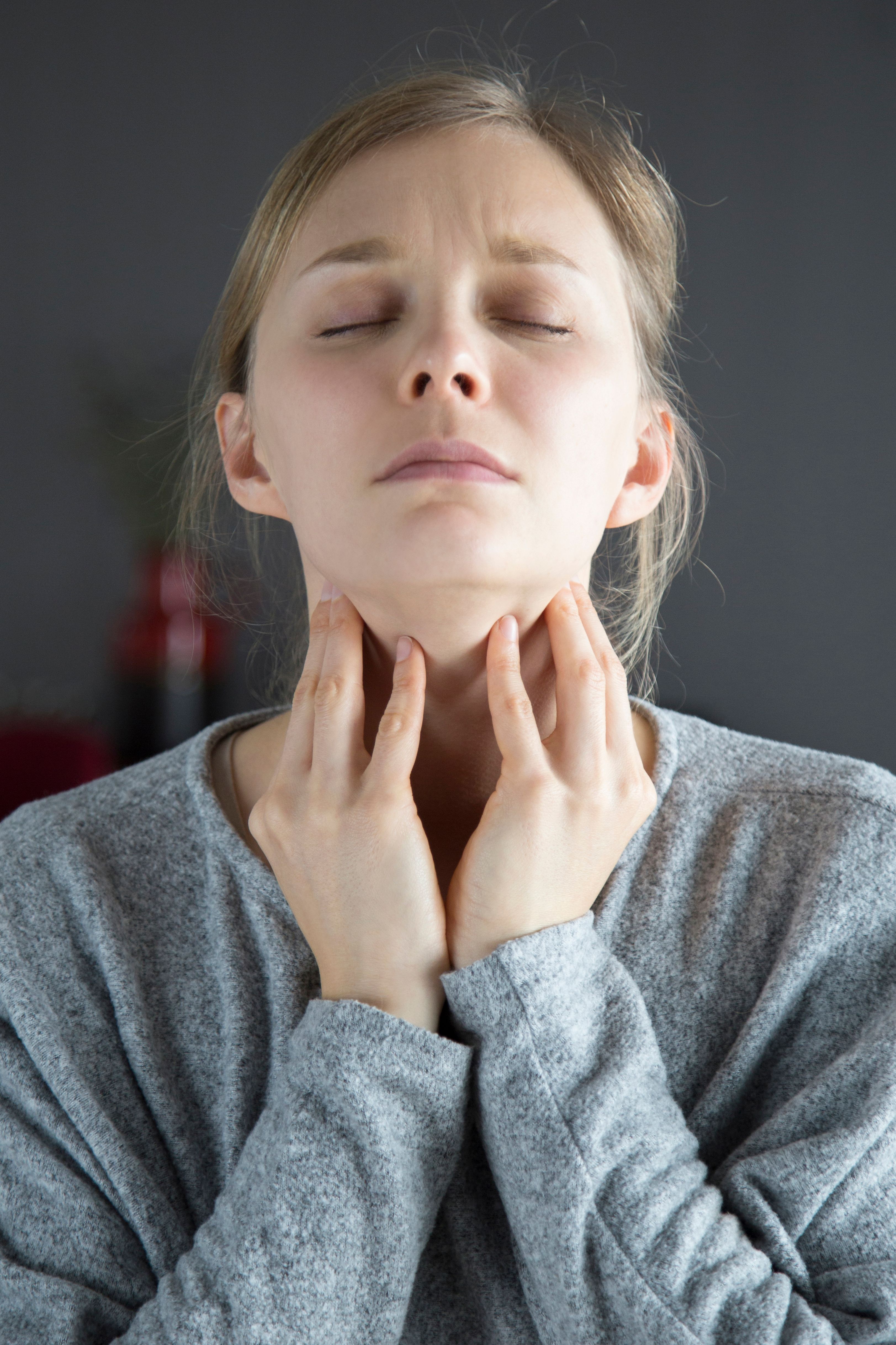 sick woman with closed eyes having sore throat touching neck (1)