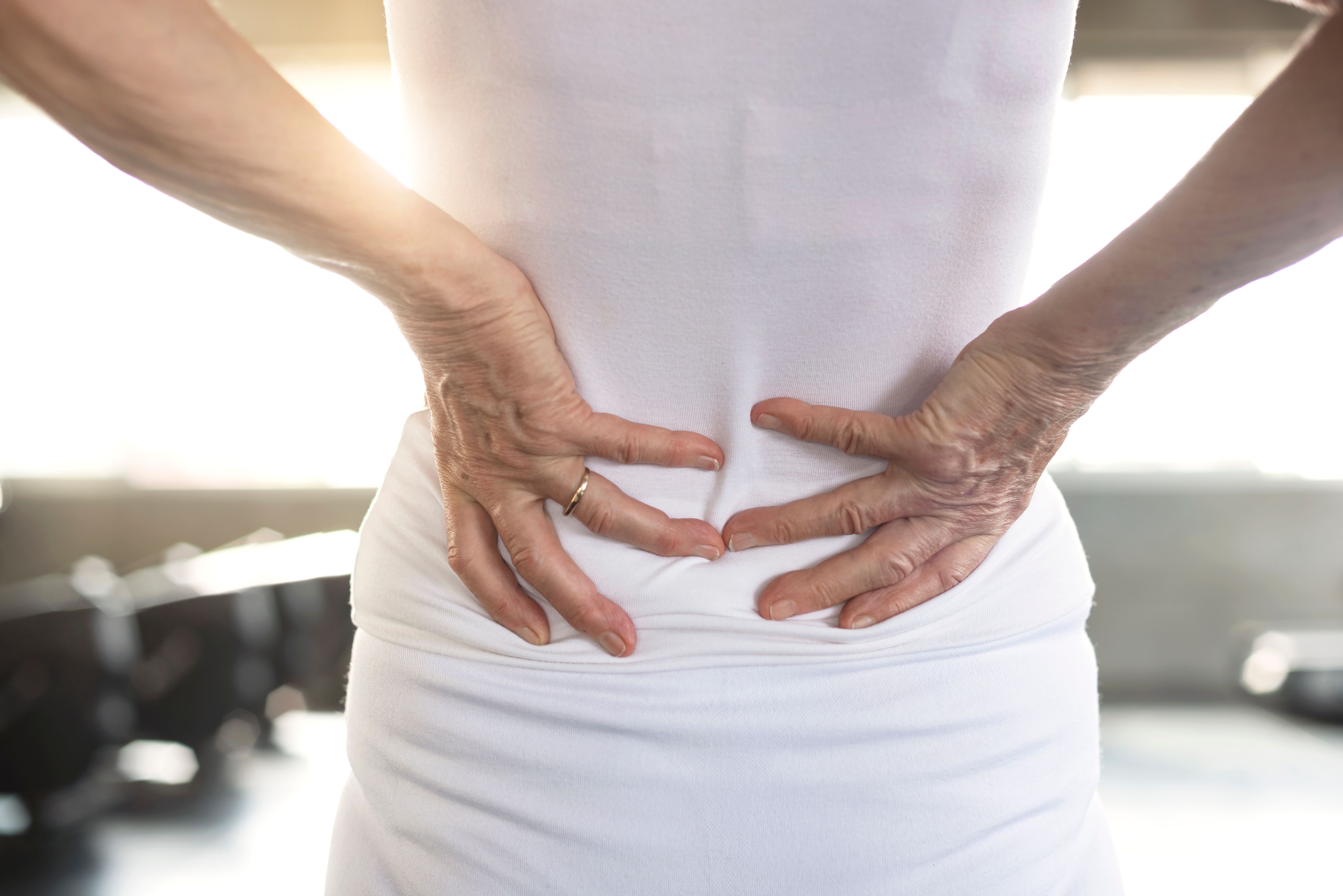 sport injury senior woman suffering from backache fitness