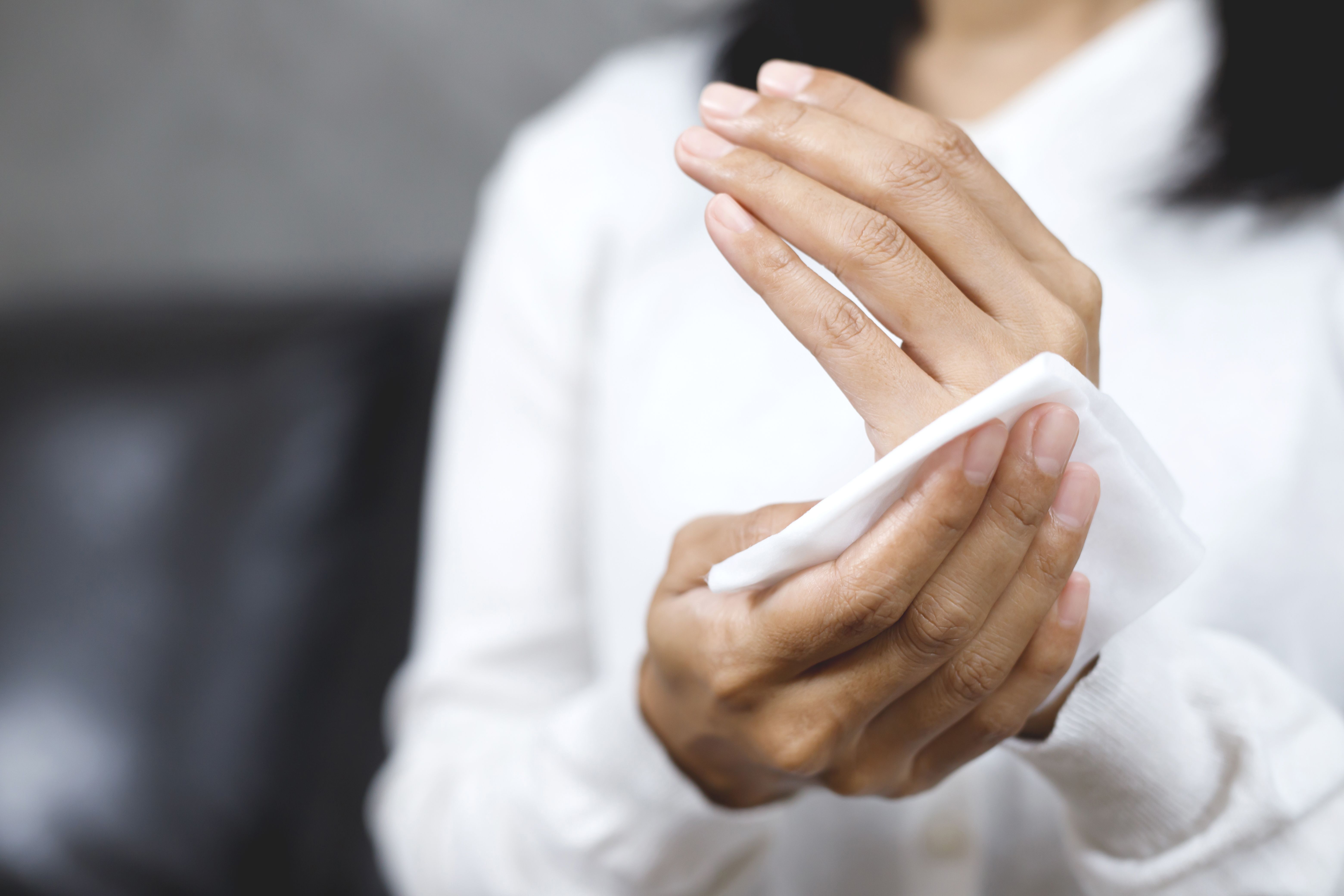 woman using tissue paper clean your hands remove germs